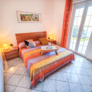 a bedroom with a bed with a table on it at Salento Delizioso appartamento con ampia corte in Torre San Giovanni Ugento