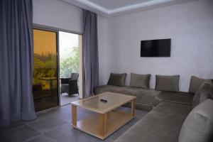 a living room with a couch and a coffee table at Ourika-camp Marrakech in El Harkat