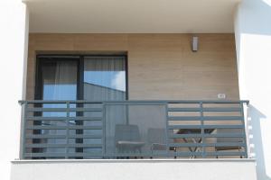 a balcony with a table and chairs on it at VISAJ Homes in Timişoara