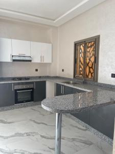 a kitchen with a granite counter top and a sink at Ourika-camp Marrakech in El Harkat