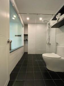 a bathroom with a toilet and a glass shower at Nomad Apartment in Nha Trang +53 photos