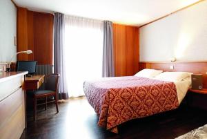 Кровать или кровати в номере La Trinitè Monboso Hotel