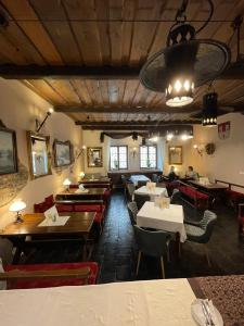 a restaurant with tables and chairs in a room at Hotel Ennius in Klatovy