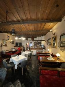 a restaurant with tables and chairs and a bar at Hotel Ennius in Klatovy