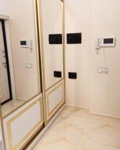 a bathroom with four shower stalls with mirrors at Премиум квартира возле метро in Baku