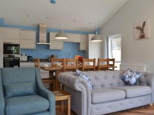 a living room with a couch and a dining room at Lords View in Ruckinge