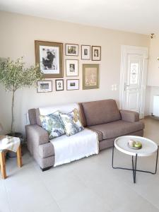 a living room with a couch and a table at Beach house in Skala Polichnitou, Lesvos, Greece in Lisvórion