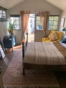 a bedroom with a bed and a couch at The Cabin in Spixworth