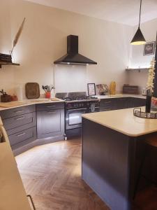 a kitchen with blue cabinets and a stove top oven at Luxury 4 Bed Family property in popular location in Sheffield