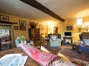 a living room with a couch and chairs at The Old Priory Cottage in Dunster