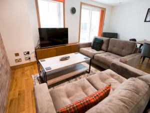 a living room with two couches and a tv at Pass the Keys Beautiful Unique 3Bed Mews Cottage House in Glasgow