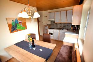 eine Küche mit einem Holztisch und einem Esszimmer in der Unterkunft Haus am Lift in Kleinarl