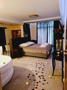 a bedroom with a bed with roses on the floor at Figaro Apartaments in Gdynia