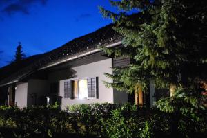a white house with a window at night at Apartments Trata in Kranjska Gora