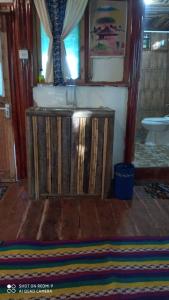 a room with a wooden stand with a rug on the floor at ZIONZURI ARTS ECOVILAGE TREE HOUSE in Mbwamaji