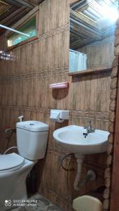 a bathroom with a toilet and a sink at ZIONZURI ARTS ECOVILAGE TREE HOUSE in Mbwamaji