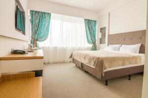 Postel nebo postele na pokoji v ubytování Gardenia Hotel & Spa