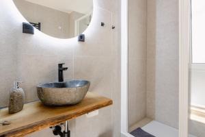 a bathroom with a sink and a mirror at Alex & Rine - Pension Zum Alten Strom in Warnemünde +41 photos