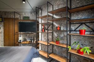 a bedroom with a stone wall with shelves at Apartment House - Delta in Sofia