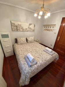 a bedroom with a bed with two towels on it at ARTZA ETXIE LA CASA EBI01934 in Bermeo