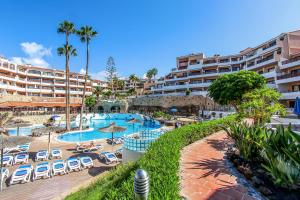 a resort with a swimming pool and a resort at Paradise Gardens - Golf del Sur in San Miguel de Abona