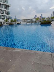 a large swimming pool in the middle of a city at Duplex Scott Garden in Kuala Lumpur
