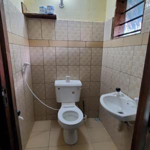 a bathroom with a toilet and a sink at 3 Bed Villa - Sleeps 6 - Wifi - Parking in Galu