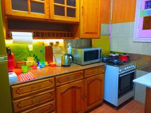 a kitchen with a microwave and a stove top oven at Fayrouzat Almndra near the sea with garden view in Alexandria