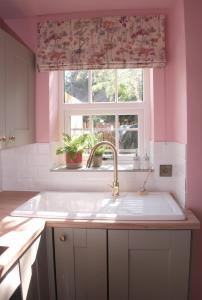 a kitchen with a sink and a window at The Gardener's Cottage in Leominster