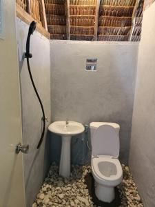 a bathroom with a toilet and a sink at Warahnus dive homestay in Kri