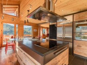 a kitchen with a stove top oven in a room at Chalet La Clusaz, 9 pièces, 13 personnes - FR-1-304-219 in La Clusaz