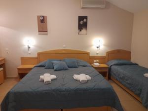 Postel nebo postele na pokoji v ubytování Hotel Serenity Tolo