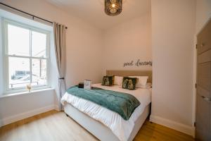 a bedroom with a bed and a window at York Place One in Harrogate