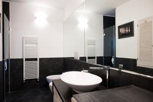 y baño con lavabo blanco y espejo. en La mansarda sul Porto en Camogli