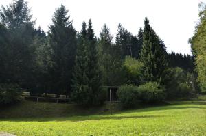 a park with trees and a sign in the grass at Penzion Svojanov in Svojanov
