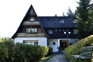 a house with a gambrel roof with a walkway in front at Penzion Svojanov in Svojanov