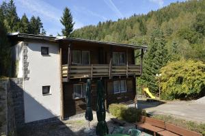 a house with a deck with a mountain at Penzion Svojanov in Svojanov