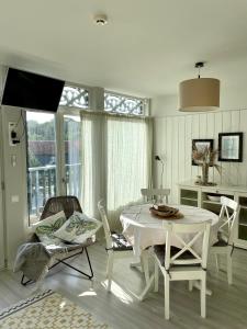 una sala de estar blanca con mesa y sillas en Preilos Kiras, en Preila