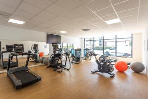 a gym with cardio equipment and exercise bikes in a room at Nemea Appart Hotel Les Hauts de Milady Biarritz in Biarritz