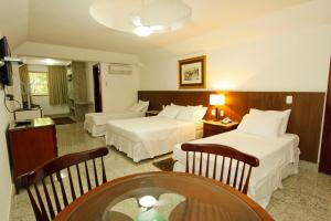 Cama ou camas em um quarto em Savassi Hotel