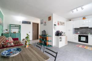 a living room with a table and a kitchen at Villa Vista Mare Cinisi in Cinisi