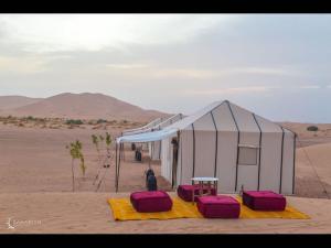 a tent in the middle of the desert at Deluxe triple room for three at Saharian Luxury Camp in Tisserdmine