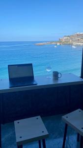 - une table avec un ordinateur portable et un verre de vin dans l'établissement Direkt am Strand - Playa Patalavaca - Doñana, à Patalavaca