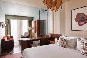 a hotel room with a bed and a desk at The Hoxton, Brussels in Brussels