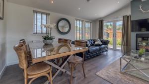 a dining room with a table and chairs and a couch at Balloch Park in Aberfeldy