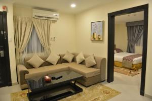 a living room with a couch and a bed at Burj Alawal in Al Jubail