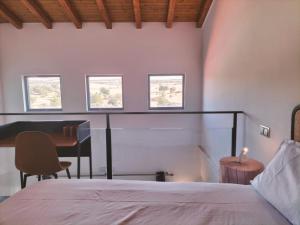 a bedroom with a bed and a desk and a piano at Apartamentos Walden by gaiarooms in Morille