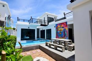 a house with a mural on the side of it at PP Pool Villa Huahin in Hua Hin