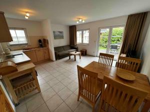 a kitchen and living room with a table and chairs at Chico in Graal-Müritz