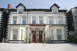 a large white building with a red door at Beech Mount Hotel - Free Parking in Liverpool